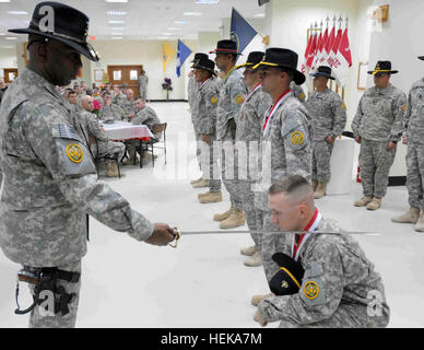 WASIT, Iraq - Le Colonel Reginald E. Allen, commandant du 3e régiment de cavalerie blindée knights un soldat nouvellement attribués à l'Ordre de Saint George sur la base d'opérations d'urgence Delta 19 mai 2011. La commande est une tradition d'armure dans laquelle ses membres au nombre de 10 000. Elle est attribuée à ceux qui démontrent le plus haut degré de discipline, d'initiative et la compétence dans la profession d'armure. Photo de l'Armée américaine par la CPS. William Bailey maintenant tradition grâce à une histoire de changement 408712 Banque D'Images