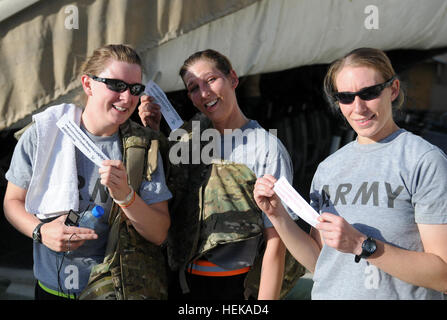 La CPS de l'armée américaine. Ashley O'Hearn (à gauche), de Pipestone, au Minnesota et de l'armée américaine de la CPS. Torey Lasater (à droite), de Conrad, de l'Iowa, les deux opérations de l'aviation brigade, spécialistes de l'armée américaine et le s.. Brenda Caldwell (centre), un sergent d'alimentation, de l'Omaha, Neb., tous avec la Garde nationale de l'Iowa, 2e Brigade Combat Team, 34e Division d'infanterie, Task Force Red Bulls, affichent fièrement leurs feuilles de suivi d'entraînement après avoir terminé le Memorial Day 'Murph' entraînement CrossFit à la benne de sport sur l'aérodrome de Bagram, la province de Parwan, Afghanistan, le 29 mai. La sueur gagne l'orgueil, de l'argent pour 415942 soldats blessés Banque D'Images