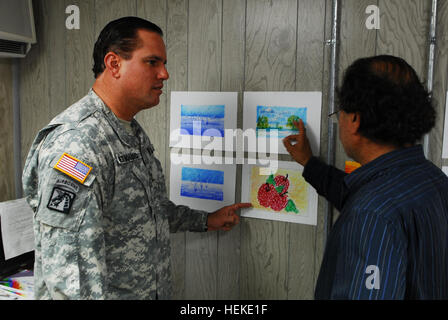 GUANTANAMO BAY, Cuba - Le Capitaine de l'Armée de José Izquierdo, Joint Task Force Guantanamo's directeur chargé de programmes, détenu reçoit une mise à jour d'Adam, le professeur d'art, sur l'œuvre d'art produit par les détenus, le 4 août 2009. L'art fournit la stimulation intellectuelle pour les détenus, et leur permet d'exprimer leur créativité. Guantanamo la foi mène sûr, humain, juridique et transparent le soin et la garde des détenus, y compris ceux qui ont été condamnés par une commission militaire et ceux commandés libéré par un tribunal. La foi mène des activités de collecte, d'analyse et de diffusion pour la pro Banque D'Images