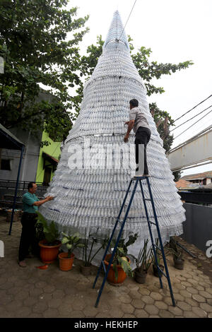 Jakarta, Indonésie. Dec 22, 2016. Les travailleurs mettent la dernière main à un arbre de Noël fabriqué à partir de bouteilles d'eau en plastique à l'extérieur de l'Église Chrétienne Pasundan dans Yogyakarta, Java ouest. L'arbre de 6 mètres qui utilise un châssis en fer et plus de 6 000 bouteilles et plus de 5 000 lumières a pris plus d'un mois à construire. © Denny Pohan/ZUMA/Alamy Fil Live News Banque D'Images