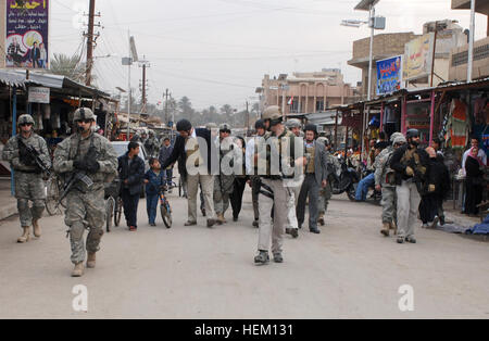 Les délégués de la House Appropriations Committee pour les opérations à l'étranger marche dans le "marché aux poissons" dans le quartier d'Shababkhar avec Adhamiya, membres de l'Équipe provinciale de reconstruction intégrés régionaux et des soldats du 2e bataillon du 319e Régiment d'artillerie de l'air, 2e Brigade Combat Team, 82e Division aéroportée, actuellement à la 3e Brigade Combat Team, 4e Division d'infanterie, une Division nationale - Bagdad, qui opèrent dans ce quartier du nord de Bagdad, le 7 février. Les délégués ont entendu un exposé sur la zone d'Adhamiya, à la proximité de la station de sécurité commune - Suleik Banque D'Images