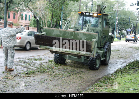 Des soldats américains avec la compagnie du génie 1023Rd, 528e bataillon du génie, la Garde nationale de la Louisiane utiliser une pelle pour nettoyer les débris dans une rue de la Nouvelle Orléans 30 août 2012, après l'ouragan Isaac a frappé la région. Isaac développé comme une tempête tropicale sur l'ouest de l'Océan Atlantique le 21 août 2012, touchant à Puerto Rico, la République dominicaine, Haïti et Cuba avant qu'il est descendu comme un ouragan sur la côte du golfe du Mexique, aux États-Unis. (U.S. Photo de l'armée par la CPS. Tarell J. Bilbo/libérés) l'ouragan Isaac 120830-A-SM895-006 Banque D'Images