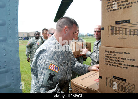 Soldats avec 1020th Ingénieur Vertical, 527e bataillon du génie de l'entreprise, recueillir l'eau d'un et MREs Black Hawk pour distribution à l'opération d'urgence le Centre à Grand Isle, 31 août 2012. La Lang a plus de 5 000 soldats et aviateurs de l'obligation de soutenir nos citoyens, autorités locales et d'État à l'appui de l'opération d'Isaac. Décharger la garde nationale de la Louisiane des fournitures à Grand Isle 120831-A-EO763-091 Banque D'Images