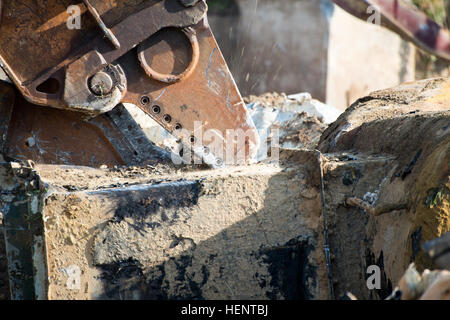 Vue rapprochée de la 5000 + PSI mâchoires d'un cisaillement de démolition Pelle hydraulique à chenilles en dehors des réservoirs de carburant jet déclassés pour expédier et leur recyclage, sur la base aérienne de Chièvres, Belgique, 18 septembre 2014. (U.S. Photo de l'armée de l'information visuelle) Courtejoie-Released Pierre-Etienne Spécialiste réservoirs POL Démolition et recyclage 140918-A-BD610-025 Banque D'Images