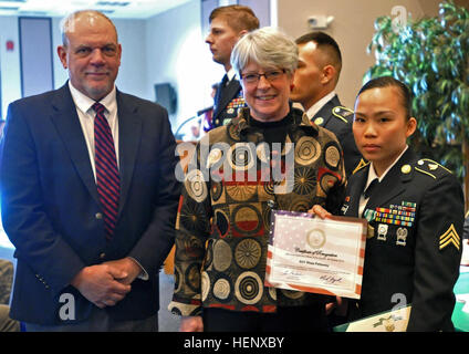 Tom Moyer, directeur régional pour le sénateur Mark Begich, Althea et Saint Martin, Adjoint spécial pour le sénateur Murkowski Liza, donner un certificat d'appréciation pour le post's top sous-officiers et soldats sur le sous-officier et soldat de la 3e et 4e trimestres de Dîner de reconnaissance à Fort Wainwright's Northern Lights Chapelle, le 22 octobre 2014. USARAK reconnaît l'excellence des soldats Stryker 141022-A-IQ085-997 Banque D'Images