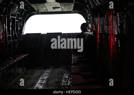 Un soldat américain de la Compagnie Alpha, 4e Bataillon, 3e Régiment d'aviation de l'aviation de combat, 3e Brigade, 3e Division d'infanterie, regarde par une fenêtre dans un CH-47 Chinook tout en menant des opérations d'infiltration de l'hélicoptère pendant l'exercice Combined Résoudre IV à l'armée américaine dans le centre de préparation interarmées multinationale Hohenfels, Allemagne, le 21 mai 2015. Résoudre combiné IV est une armée Europe-dirigé l'entraînement à l'exercice une brigade multinationale et renforcer l'interopérabilité avec les alliés et les pays partenaires. Les trains combinés résoudre sur terre unifiée des opérations contre une menace complexe tout en améliorant la lutte contre Banque D'Images