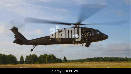 Un Black Hawk UH-60M hélicoptère exploité par la Compagnie B, 43e Bataillon d'hélicoptères d'assaut, 3e régiment de cavalerie, 3e Division d'infanterie, commence c'est montée à environ 1200 pieds de sorte qu'une force multinationale composée de soldats américains affectés à Dog Company, 1er Bataillon (Airborne), 503e Régiment d'infanterie, 173ème Infantry Brigade Combat Team (Airborne), et les Forces terrestres lituanienne soldats affectés au bataillon Algirdo peut entraîner ensemble comme parachutistes et gagner le très convoité des ailes de saut à l'étranger au cours de ces exercices sont tenus au grand Hetman Jonusas lituanienne Radvila, Régiment de formation de Ruk Banque D'Images