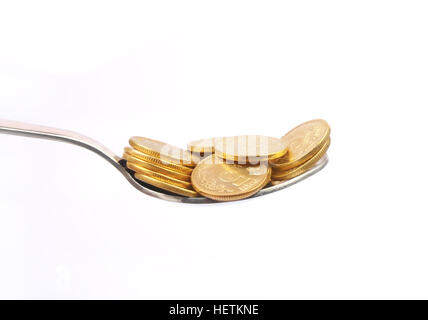 Pièce d'or avec cuillère en argent Banque D'Images