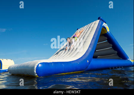 Girl playing on inflatable slide, Seaside Heights, New Jersey, USA Banque D'Images