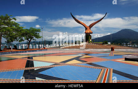 Eagle Square Accueil Emplacement : Langkawi, Kuah signification : elle agit comme un symbole de l'île de Langkawi. Comment rejoindre : On peut facilement rejoindre ici par l'embauche de taxis, ou par les bus d'embarquement de l'île. La Dataran Lang, littéralement l'Eagle Square, est le tout premier monument qui vient à travers le regard de visiteurs, en arrivant par ferry, à Langkawi. Situé à côté de lagenda Park près de la place de Kuah, dispose d'une magnifique statue d'un brun rougeâtre eagle toutes orientées pour un vol. L'aigle, avec ses immenses ailes brun, est perché sur une roche massive, à la distance à la grande côte Banque D'Images