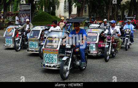 Un pedicab Philippine s'appelle une traysikad trisikad,--ou--ou tout simplement sikad padyak, de la Philippine mot signifiant à tramp stamp ou les pieds. Il est fait par le montage d'un side-car à un vélo traditionnel. Ils sont utilisés principalement pour transporter des passagers sur de courtes distances le long de plus petits, plus les rues résidentielles, souvent à destination ou en provenance de jeepneys ou autres véhicules d'utilité publique. Ils sont également utilisés pour le transport du fret trop lourd à porter à la main et sur une distance trop courte ou des routes trop chargé pour le transport automobile, comme un cochon. Pendant la saison des pluies, elles sont utiles comme un moyen d'éviter de marcher d'inondations w Banque D'Images