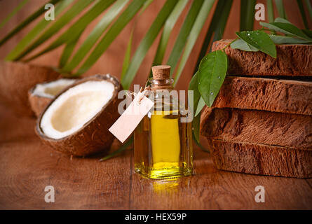 coconut oil in the bottle with fruits around Banque D'Images