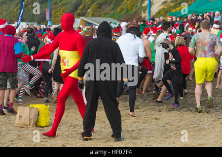 Bournemouth, Dorset, Royaume-Uni. 25 décembre 2016. Jour de Noël 25 décembre 2016. Trempette de Noël blanche à Boscombe, Bournemouth, Dorset, Royaume-Uni. Les courageux volontaires plongent dans la mer froide et agitée pour nager, pour la 9e année de l'association caritative nageant le matin de Noël, vêtus de costumes habillés de fantaisie et amassant de l'argent pour Macmillan Caring local à Christchurch, une unité de soins palliatifs spécialisée pour les patients dans la communauté locale. Des centaines prennent part à l'événement qui est devenu une tradition populaire pour beaucoup avant leur déjeuner. Se réchauffer pour l'événement © Carolyn Jenkins/Alay Live News Banque D'Images