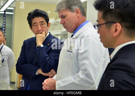 Le Premier ministre japonais Shinzo Abe, à gauche, est informé par le Dr John Byrd au cours d'une visite du laboratoire de la Défense POW/MIA Agence Comptable 26 décembre 2016, à Pearl Harbor, Hawaii. Abe est le premier chef japonais à la vue du public site de l'attaque de Pearl Harbor. Banque D'Images