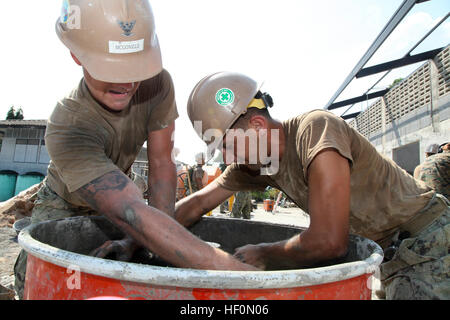 U.S. Navy Seabees Builder Constructionman McGonigl Patrick 3e classe et 3e classe Utilitiesman avec Hayden Brandon Mobile Naval Construction Battalion quarante essayer de desserrer les accessoires sur une table de mixage au cours de la construction d'un bâtiment multifonctionnel au temple Wat Chalheamlap l'école dans le cadre de l'exercice 2012, Gold Cobra Chon Buri, Royaume de Thaïlande, le 1er février 2012. CG 12 offre des possibilités de formation uniques et dynamiques de participation des partenaires militaires, mais aussi la promotion des relations entre militaires et membres de la communauté locale. (U.S. Marine Corps photo par Lance Cpl. Carl Payne/libérés) Cobr Banque D'Images