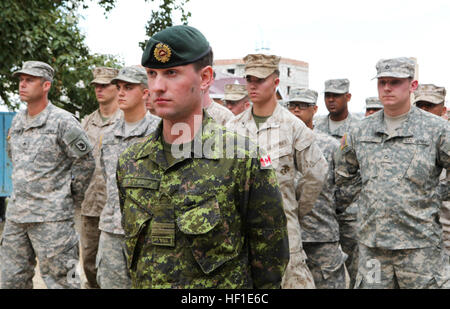 Le capitaine des Forces canadiennes Patrick Reid, ingénieur à la 1re Unité d'appui du Groupe d'appui opérationnel conjoint, à Kingston (Kingston, Ontario), conduit une formation multinationale de Marines des États-Unis à partir de la 9e Bataillon de soutien du génie de l'Armée de Washington et les soldats de la Garde Nationale avec des troupes, au cours de la commande 96e d'une cérémonie d'inauguration de l'hôtel récemment rénové, le Erdmiin Orgil School dans le district de Nalaikh, Ulaanbaatar, Mongolie, 13 août. Le projet a eu lieu dans le cadre de l'exercice KHAAN QUEST 2013. Les ingénieurs de l'États-Unis, la Mongolie et le Canada ont travaillé côte à côte, afin de remplacer le toit, fenêtres, escaliers et interio avant Banque D'Images