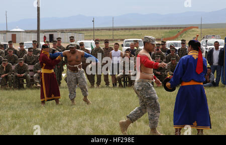 Des soldats américains, portant lutte mongole en tissu, effectuer la danse de l'aigle avant wrestling lors d'une mini-festival Naadam le 27 juin à cinq Hills Zone de formation, Taiwan, en Mongolie, au cours de l'effort KHAAN QUEST 2014. Naadam mongol traditionnel est un festival qui se déroulera du 11 au 13 juillet chaque été. Il se compose de lutte mongole, les courses de chevaux et le tir à l'ARC. Comme une démonstration de l'hospitalité pour les clients, les Mongols souvent l'hôte d'une mini-version de ce festival. KQ14 est normalement prévu à l'exercice multinational, organisé chaque année par les forces armées mongoles et co-parrainé cette année par l'armée des États-Unis, du Pacifique et de l'U.S. Banque D'Images