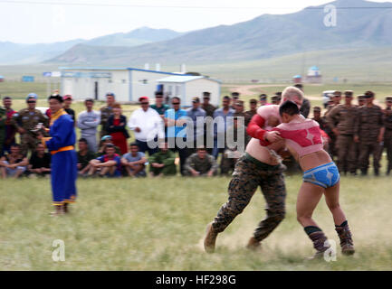 La lutte mongole portant des vêtements, un mongol se débat avec la Marine américaine lance le Cpl. Ethan R. Engelhardt lors d'une mini-festival Naadam le 27 juin à cinq Hills Zone de formation, Taiwan, en Mongolie, au cours de l'effort KHAAN QUEST 2014. Naadam mongol traditionnel est un festival qui se déroulera du 11 au 13 juillet chaque été. Il se compose de lutte mongole, les courses de chevaux et le tir à l'ARC. Comme une démonstration de l'hospitalité pour les clients, les Mongols souvent l'hôte d'une mini-version de ce festival. KQ14 est normalement prévu à l'exercice multinational, organisé chaque année par les forces armées mongoles et co-parrainé cette année par l'armée américaine, Paci Banque D'Images