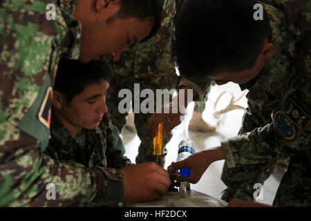 Les soldats de l'Armée nationale afghane affecté à la 215e Corps, démonter une unité de climatisation dans le cadre d'une série de cours sur l'entretien de l'infrastructure sur la base d'opération avancée Tombstone, province de Helmand, Afghanistan, 14 août 2014. Le cours est conçu pour fournir des Afghans avec instruction formelle et l'application pratique avec l'équipement qu'ils vont hériter comme les forces de la coalition se retirer. (Official U.S. Marine Corps photo par Lance Cpl. Darien J. Bjorndal, Marine Expeditionary Brigade Afghanistan/) Parution Tombstone FAB--nous enseigne à la maintenance de l'infrastructure de l'Armée Afghans comme nous avec Banque D'Images