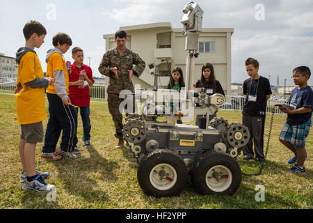 Le Sgt. Larry K. Hicks, quatrième à partir de la gauche, explique les capacités d'un Remotec robot Andros F6 aux étudiants le 20 février à l'extérieur du camp Foster Centre communautaire, Okinawa, Japon, au cours d'une démonstration de destruction des engins explosifs. L'Andros Remotec F6 robot est un robot stables, qui fournit une base des Marines de NEM avec robot stable fiable pour être utilisé pour les opérations de base. La présentation faisait partie de l'activité d'éducation du ministère de la Défense concours robotique first d'Okinawa entre écoles primaires, collèges et lycées situés sur Okinawa. Hicks est un Kansas City, Mo., autochtones et un e Banque D'Images