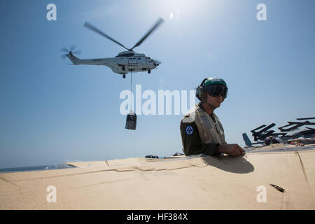 Le Cpl. Joseph Dibuono, une cellule à rotors basculants avec Marine mécanicien de l'escadron 365 à rotors basculants moyen, 24e Marine Expeditionary Unit, maintient enfoncé un morceau de carton que les fournitures sont effectuées sur le quai de transport amphibie USS New York (LPD 21) lors d'un ravitaillement vertical en mer, le 24 avril 2015. La 24e MEU est embarqué sur les navires de l'Iwo Jima et ARG est déployé pour maintenir la sécurité régionale dans la 5e flotte américaine Zone d'opérations. (U.S. Marine Corps photo par le Cpl. Todd F. Michalek/libérés) 24e MEU, ravitaillement en mer verticale 150424-M-YH418-004 Banque D'Images