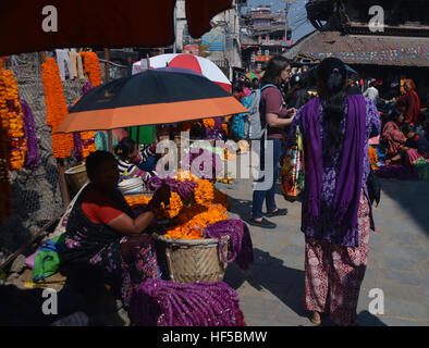 Femme népalaise pour vendre des guirlandes de fleurs aux couleurs vives pour le Festival de la lumière (Deepawali) à Katmandou, Népal.Asie. Banque D'Images