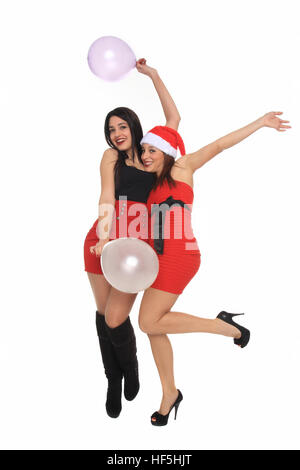 De belles jeunes filles avec tenue de Noël s'amusant avec des ballons Banque D'Images