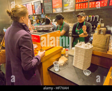 Espresso Starbucks baristas occupés à faire des boissons pendant le premier jour de l'événement promotionnel Cheer Starbucks à New York, le vendredi, Décembre 23, 2016. Pour les 10 jours, sauf le jour de Noël, Starbucks est loin de donner un grand verre d'espresso de votre choix entre 1 et 2h00 au tour de choix de 100 magasins à travers le pays. (© Richard B. Levine) Banque D'Images