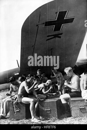 L'image de propagande nazie dépeint des soldats de la Wehrmacht allemande lors d'une pause déjeuner sur un aérodrome à l'ombre de l'aile d'un combattant (Dornier do 217?). La photo a été publiée en septembre 1939. Fotoarchiv für Zeitgeschichte - PAS DE SERVICE DE FIL - | utilisation dans le monde entier Banque D'Images