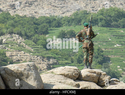 Un soldat de l'Armée nationale afghane observe une vallée tandis que la police nationale afghane mène une opération de recherche d'armes et d'insurgés dans un village voisin pendant l'opération Nowruz Jhala. Banque D'Images