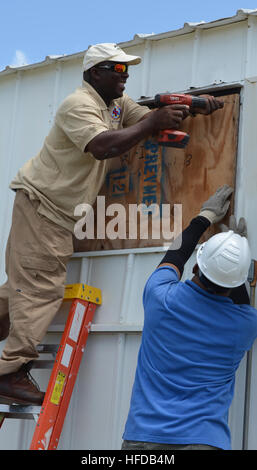 L'Hôpital de la Marine américaine Guantanamo conseil le personnel des installations de Windows sur les bâtiments de l'hôpital à l'avance de possibles des vents violents de la tempête tropicale Isaac. Les prévisions actuelles ont un impact sur le système météo Guantanamo comme une tempête tropicale tôt samedi matin, avec des vents entre 40 et 45 mi/h avec des rafales de plus de 60 mi/h, un 1 à 3 pieds de tempête et 3 à 6 pouces de pluie. (U.S. Photo de la marine par Stacey Byington/libéré) la tempête tropicale Isaac preps 120823-N-CD652-001 Banque D'Images