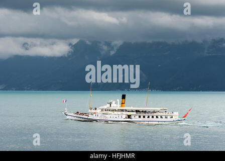 Les nuages bas foncé dans les rouleaux au-dessus de la CGN Rhône, un bateau à aubes sur le Lac Léman, Lausanne, Vaud, Suisse Banque D'Images