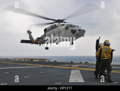 101207-N-9950J-107 MER DES PHILIPPINES (31 déc. 7, 2010) l'Aviation Boatswain's mates diriger l'atterrissage d'un Japon d'autodéfense maritime SH-60K Sea Hawk lors des qualifications d'appontage à bord de l'avant-déployé d'assaut amphibie USS Essex (DG 2). Essex est une partie de l'avant-groupe amphibie Essex déployée et participe à l'exercice vif épée, un exercice bilatéral visant à renforcer les opérations militaires des États-Unis et du Japon. (U.S. Photo par marine Spécialiste de la communication de masse 2e classe Greg Johnson/libérés) US Navy 101207-N-9950J-107 maître de manœuvre de l'Aviation Banque D'Images