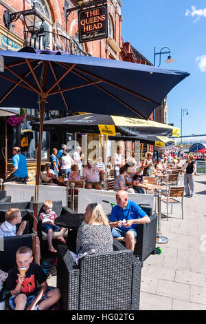 Front de l'Anglais à Ramsgate avec des gens assis à des tables et des chaises à l'ombre des parasols, profitant des boissons et de la nourriture par temps chaud en été. Banque D'Images