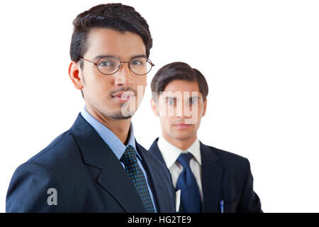 Portrait of smiling businessmen standing against white background Banque D'Images