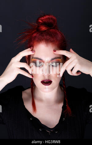 Red haired model with creative makeup in tribal style et couleurs automnales Banque D'Images