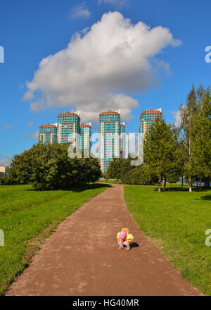 Petite fille en jaune vêtements sur une promenade dans le parc. Banque D'Images