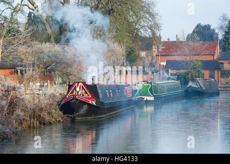 Canal boat avec fumeurs cheminée sur le canal d'oxford sur un matin glacial de décembre. Cropredy, Oxfordshire, Angleterre Banque D'Images