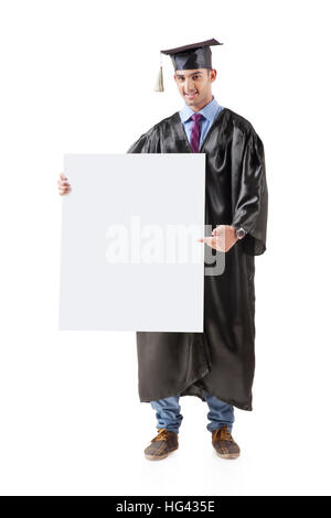 Portrait of happy graduate student holding empty banner. Isolated on white Banque D'Images