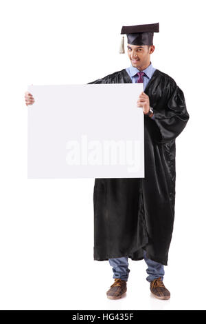 Portrait of happy graduate student holding empty banner. Isolated on white Banque D'Images