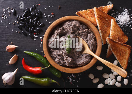 La cuisine mexicaine : pate de haricots noirs close-up sur la table horizontale vue du dessus. Banque D'Images