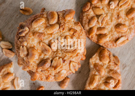 Les cookies d'arachide croquant salé avec des miettes et des morceaux sur une plaque de bois vue du haut vers le bas Banque D'Images