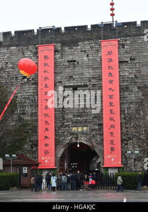 Nanjing, Jiangsu Province de la Chine. Jan 7, 2016. Personnes voir couplets géant accroché sur le mur de la ville de la dynastie des Ming (1368-1644), à Nanjing, capitale de la province de Jiangsu, Chine orientale, le 7 janvier 2016. Les 16 mètres de long ont été couplets accroché au mur pour la célébration de la prochaine fête du printemps qui tombe le 28 janvier. C'est une tradition pour les Chinois à coller sur les murs des couplets pour solliciter la bonne chance pendant le Festival du printemps. © Sun pouvez/Xinhua/Alamy Live News Banque D'Images