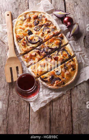 Tranches de tartes flambées et de vin rouge sur la table. Vue supérieure verticale Banque D'Images