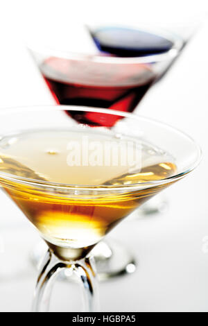 Trois verres à cocktail avec : Liqueur de pêche liqueur de Curaçao bleu, orange et rouge Banque D'Images