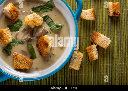 Crème de champignons soupe dans Bol en céramique et les croûtons sur la table Banque D'Images