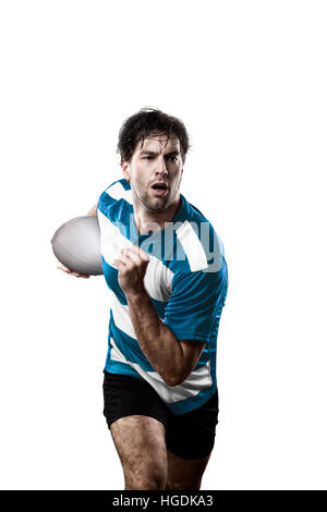 Joueur de Rugby dans un uniforme bleu d'exécution. Fond blanc Banque D'Images