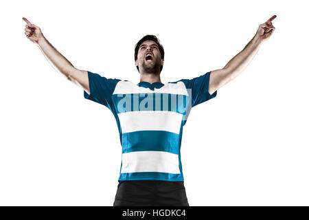 Joueur de Rugby dans un uniforme bleu de célébrer. Fond blanc Banque D'Images