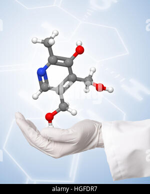 Scientist holding molécule modèle sur fond bleu avec formule chimique Banque D'Images