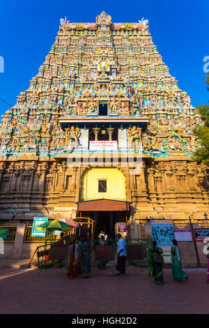 Fidèles hindous entrant dans la tour est, depuis l'entrée de la passerelle les gardes de sécurité à Meenakshi Amman Temple au Tamil Nadu Banque D'Images